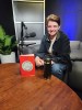 Author and organizer Jaz Brisack with a copy of their new book, "Get on the Job and Organize," at The Real News Network studio in Baltimore, MD, on June 21, 2025.