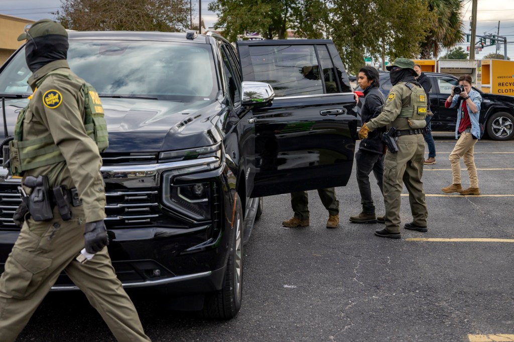 Members of US Immigration and Customs Enforcement (ICE) and US Customs and Border Patrol (CBP) detain a immigrant landscaper in New Orleans, Louisiana, on December 3, 2025. The US Department of Homeland Security announced on Wednesday it has launched a federal immigration enforcement operation, named "Operation Catahoula Crunch," in the New Orleans area. Photo by Michael Nigro.