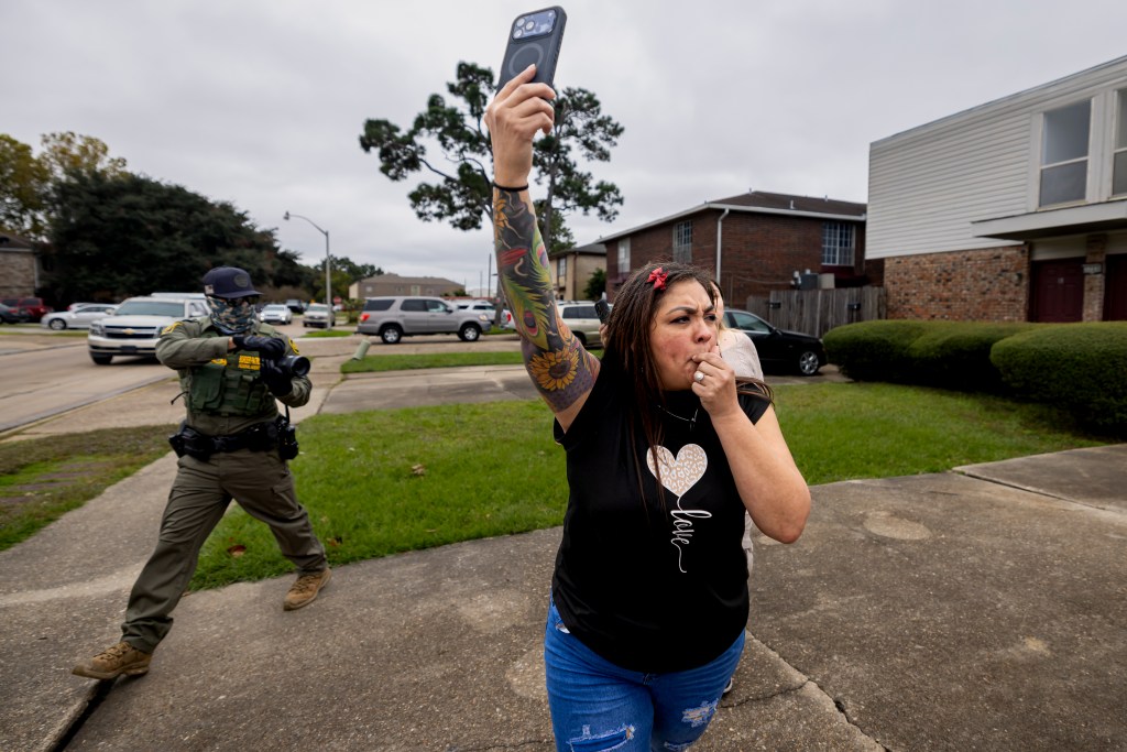 A women blows a whistle alerting community members of the presence of U.S. Border Patrol and immigration enforcement officers sweeping the streets on December ​5, 2025, in New Orleans, Louisiana. Federal agents participating in 'Catahoula Crunch,' patrol through ​New Orleans neighborhoods and surrounding suburbs searching for undocumented immigrants. Photo by Michael Nigro.