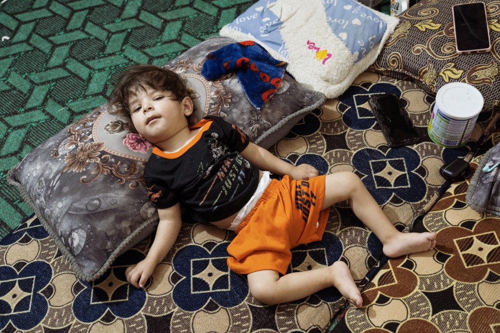 Confined to a mattress in his Fallujah home, Ayan is among the young victims of the toxic legacy left by the 2004 bombardment—his condition one of many that point to ongoing contamination. Photo by Jaclynn Ashly.